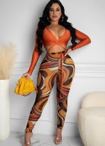 Conjunto de top corto de manga larga atado con envoltura naranja sexy de otoño y conjunto de pantalones ajustados estampados