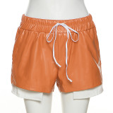 Pantalones cortos de cintura alta con cordones de cuero PU de color de contraste de moda para mujer