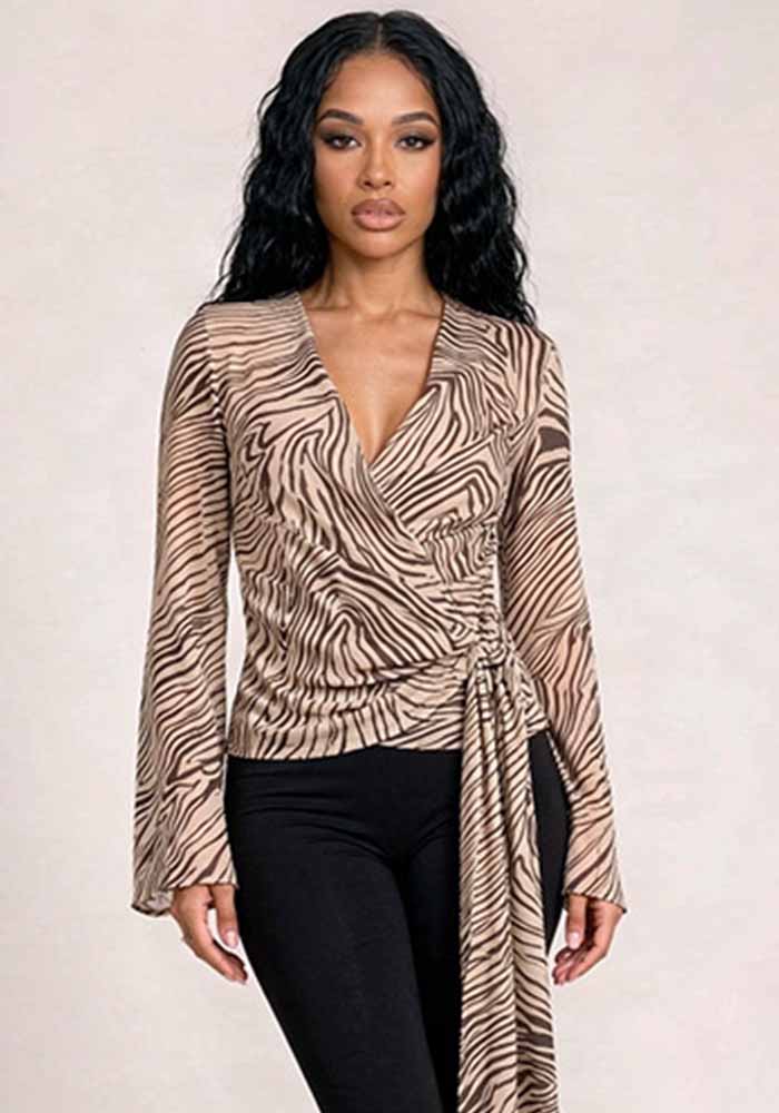A brown and cream zebra-print blouse has a wrap-style front, long sleeves and a side tie.