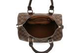 A stylish women's crossbody bag with a checkered pattern, featuring dual handles and an adjustable shoulder strap.
