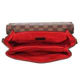 A stylish checkered crossbody bag with an adjustable shoulder strap and gold-tone hardware.