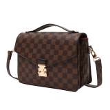 A stylish checkered crossbody bag with an adjustable shoulder strap and gold-tone hardware.