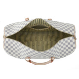 A stylish checkered duffel bag with beige leather straps, ideal for use as weekenders bags, a travel bag, or a gym bag.
