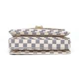 A stylish checkered crossbody bag with an adjustable shoulder strap and gold-tone hardware.