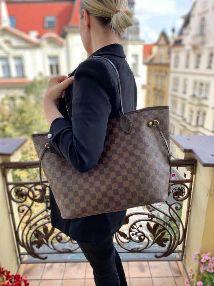 Rich brown checkered tote, paired with a sleek black blazer. Timeless design blends sophistication and functionality—ideal for city outings or work days. Effortless luxury that elevates any refined look.